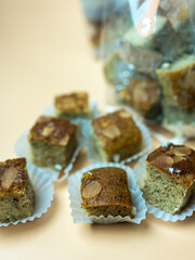 Close up of soft and sweet square shaped banana cake and almond on top.