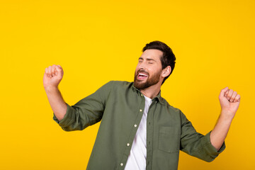Fototapeta premium Photo of nice young man good mood dancing wear shirt isolated on yellow color background