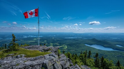 Canadian flag waving on flagpole atop a mountain peak, stunning panoramic view of forests and lakes
