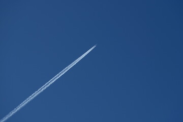 Airplane trails in the blue sky. Airplane trail on blue sky.