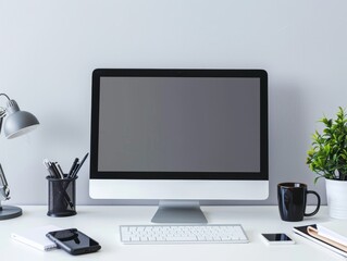 Fototapeta premium A professional workspace with a desktop computer, a phone, and office supplies neatly arranged, with a significant amount of blank space above for text.