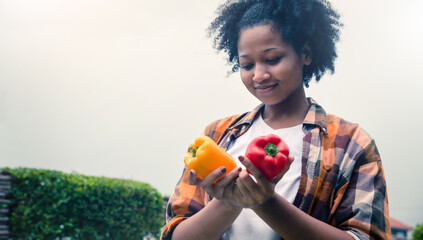 Happy teenager holding vegetable at fall day in organic farm. Harvesting on the farm. Vintage tone