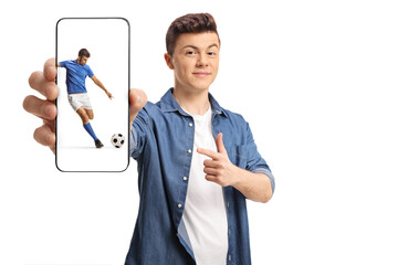 Teenager holding a smartphone with a football player kicking a ball on the screen