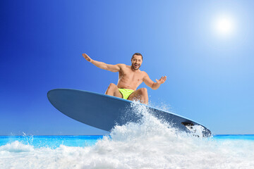 Young man riding a surfboard
