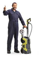 Worker in a uniform with a high pressure washer machine gesturing thumbs up