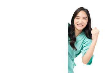 Confident young Asian female nurse peeking around a blank board, smiling and giving hand raised, wearing green medical scrubs. The image captures a positive and encouraging healthcare professional  