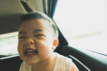 Asian baby boy funny mood in car