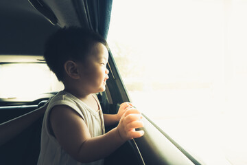 Asian baby boy enjoy in car