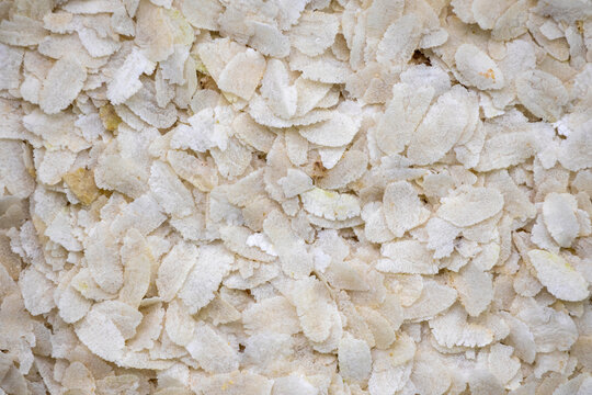Flattened rice or Chira as background.