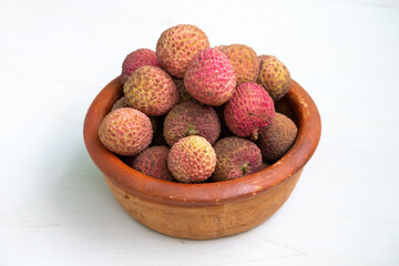 A clay pot filled with delicious ripe lychees.