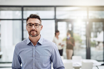Fototapeta premium Portrait, male leader and glasses in office for meeting, entrepreneur and company in workplace. Corporate professional, mature manager or executive with about us, pride and working with experience