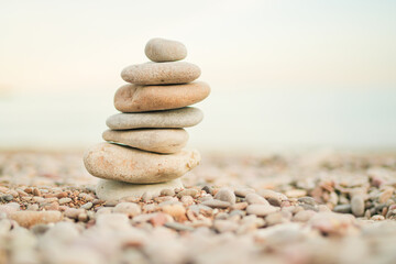 A stack of rocks on a beach. The rocks are white and grey. The beach is calm and peaceful