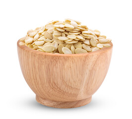 Pumpkin seeds in wood bowl isolated on white background
