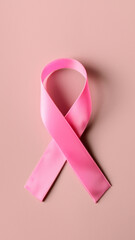 Pink Breast Cancer Awareness Ribbon on Smooth Pink Background in Daylight