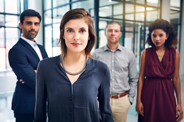 Obraz premium Portrait, leader and woman with group of business people in office with confidence, pride and diversity. Teamwork, professional consultant and project manager with support, opportunity and about us