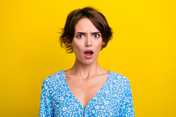 Photo of shocked surprised young lady dressed flower print top open mouth isolated yellow color...