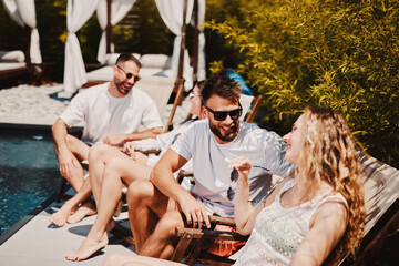 Young group of people having fun by the pool