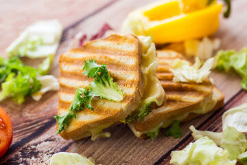 fried toasts with filling, salad leaves, tomatoes