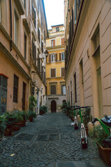 a street with old architecture and scooters