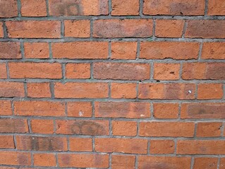 A grimy red brick wall