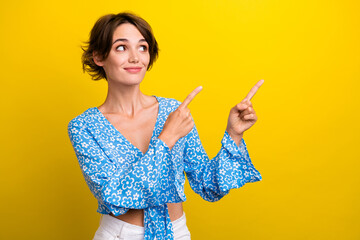 Photo of dreamy shiny young lady dressed flower print top showing two fingers looking empty space...