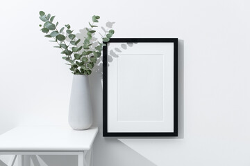 Blank portrait frame mockup with copy space in white minimalistic interior