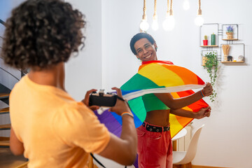 Gay man waving lgbt rainbow flag while couple taking photos