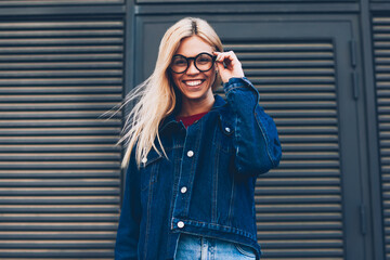 Below portrait of stylish positive young woman with blonde hair posing at camera.Cheerful hipster...