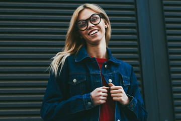Portrait of carefree young woman with eyewear laughing while posing at camera.Blonde hipster girl...