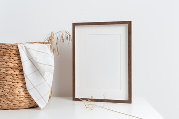 Wooden portrait picture frame mockup with copy space for print in scandinavian style interior,...