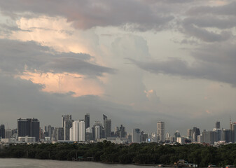 Obraz premium Beautiful Clouds in the Sky over Large Metropolitan City of Bangkok. View of Skyscrapers and Dramatic Sky before Sunset, Copy space, Selective focus.