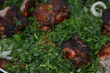 Grilled meat in a large amount of green dill