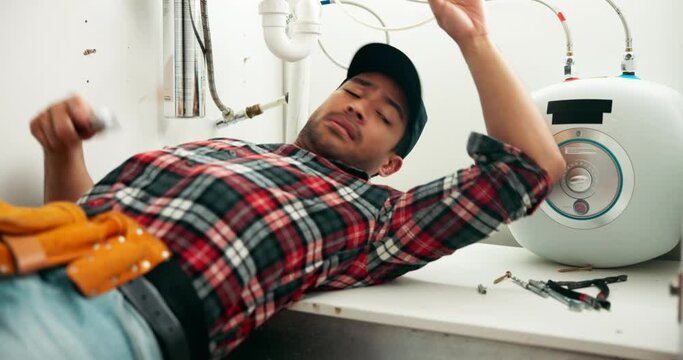 Man, plumber and pipe with wrench for repair, maintenance or leak on sink, fix or service at home. Young male person, handyman or plumbing tools on faucet, basin or water leakage in bathroom at house