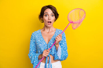 Photo of speechless girl with bob hair dressed print blouse astonished staring hold butterfly net...