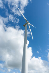 Low point of view white wind turbine