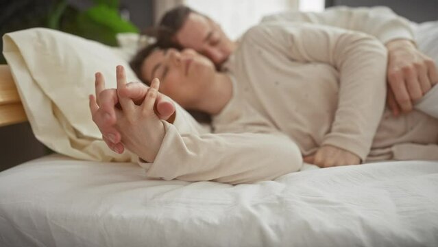 A loving couple cuddles in bed, portraying affection, intimacy, and the comfort of a shared home.