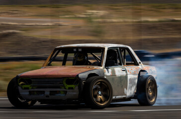 fast drift car drifting with smoke smokey tires on asphalt, speeding car vehicle driving