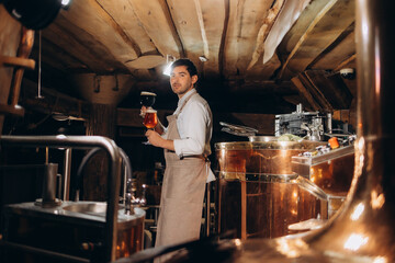 Man tasting fresh beer in a brewery