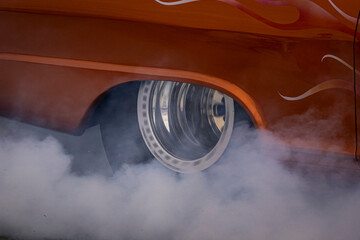 Hot rod car vehicle burnout with smoke burning tires, burning rubber fast car
