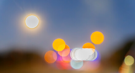 Blurred array of vehicle lights  on highway in rear vision mirror.