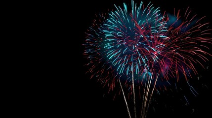 Obraz premium Fireworks light up the night sky in a dazzling display of color and light.