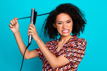 Photo of stressed angry lady dressed print shirt straighten hair curls isolated teal color...