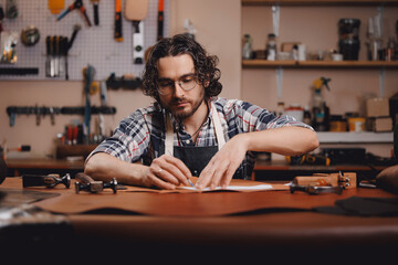 Portrait man tailor in manufacture workshop for leather handmade craft product