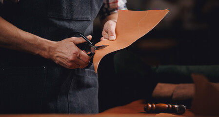 Banner tailor industry craftsman. Leather rolls and tools for handmade craft in workshop