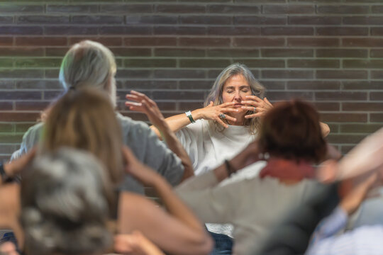 Meditation guidance with a group of elderly people. Mental health concept