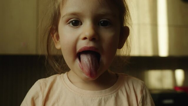 Mischievous girl eating marshmallow, playful, fun moment
