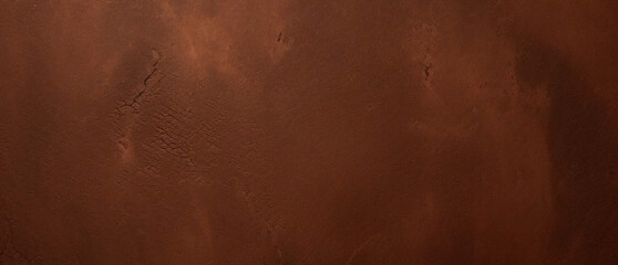 Close-up texture of reddish-brown surface with rugged and cracked patterns
