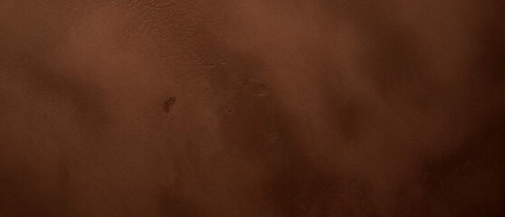 Fototapeta premium Close-up texture of reddish-brown surface with rugged and cracked patterns