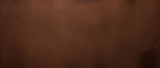 Close-up texture of reddish-brown surface with rugged and cracked patterns