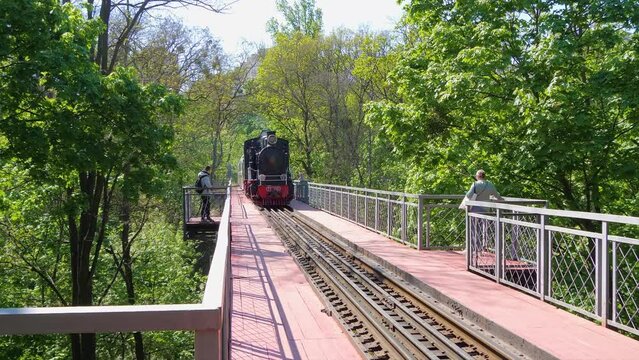 Steam Children Train on the Bridge in Sunny Day